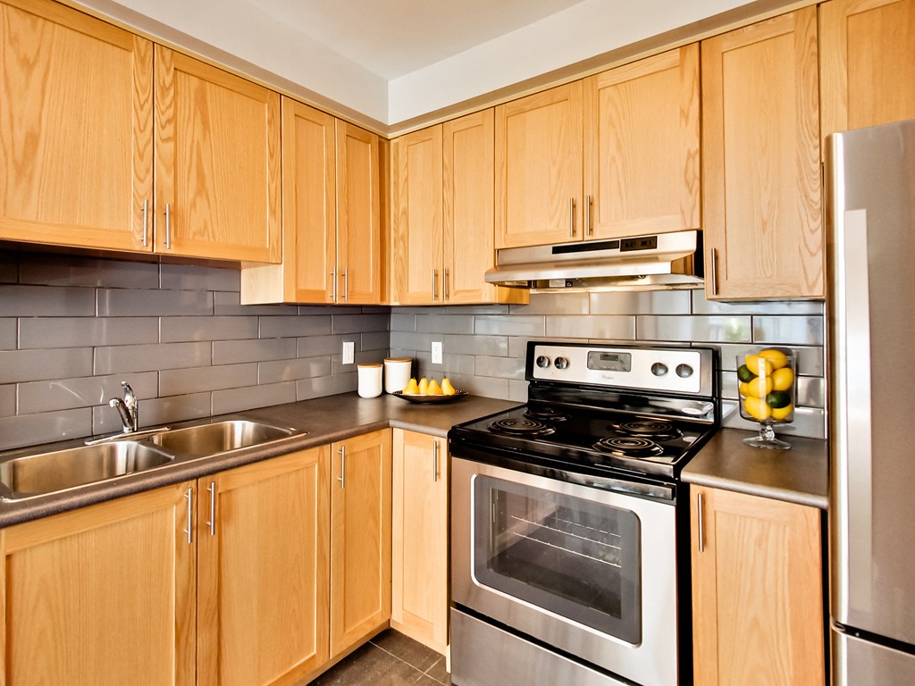 a kitchen with stainless steel appliances and wooden cabinets