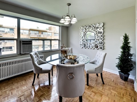 a dining room with a table and chairs and a window