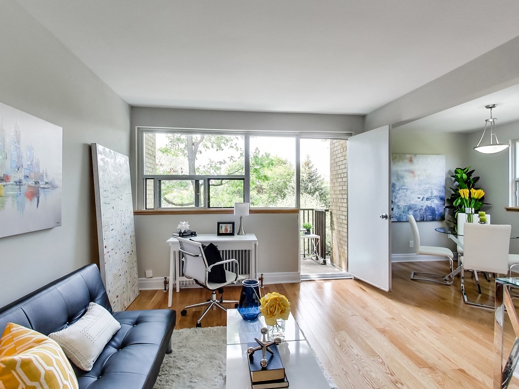 A living room with a blue couch and a white chair.