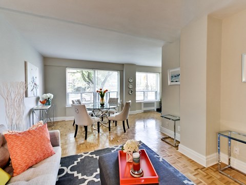 a living room with a couch and a table with chairs