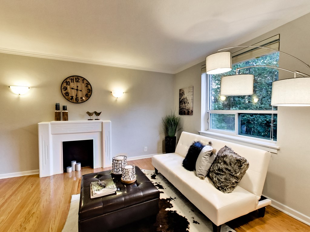 a living room with a white couch and a fireplace