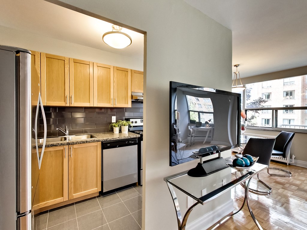 a kitchen and dining room with a flatscreen tv on the wall