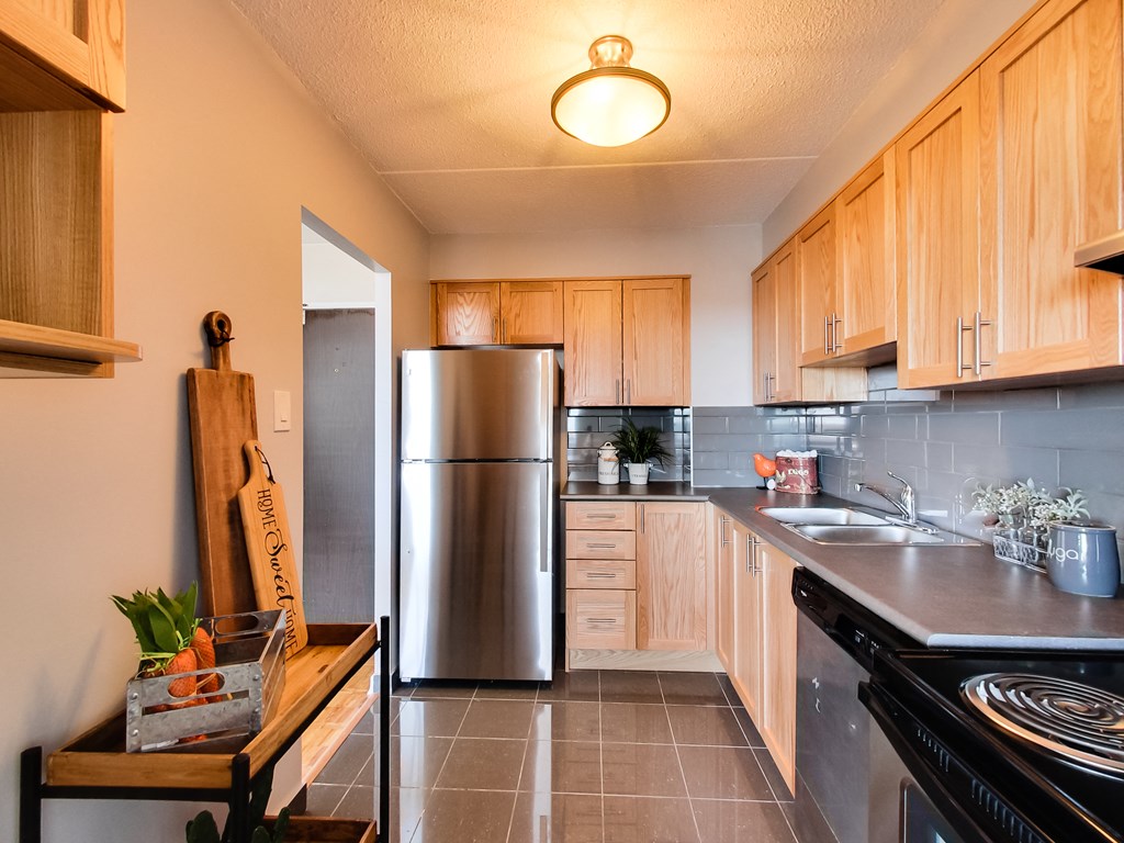 a kitchen with stainless steel appliances and wooden cabinets