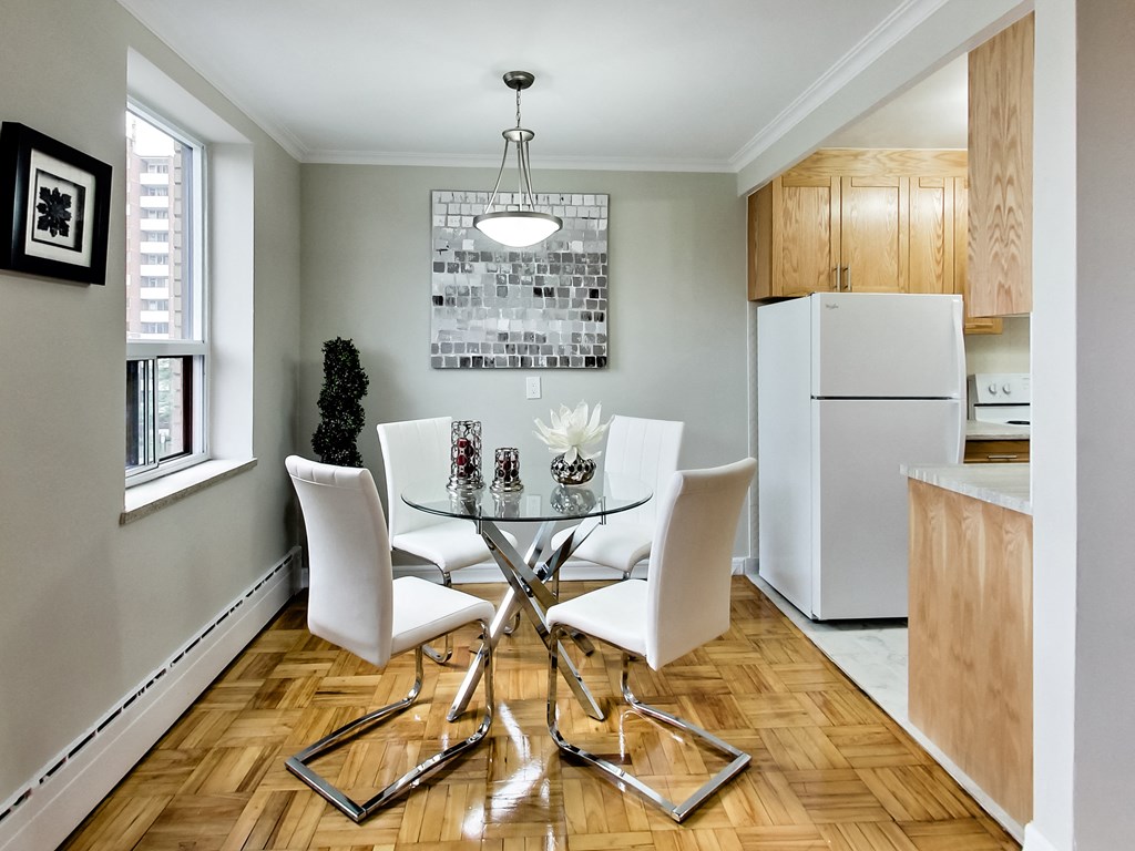 a dining room with a glass table and white chairs