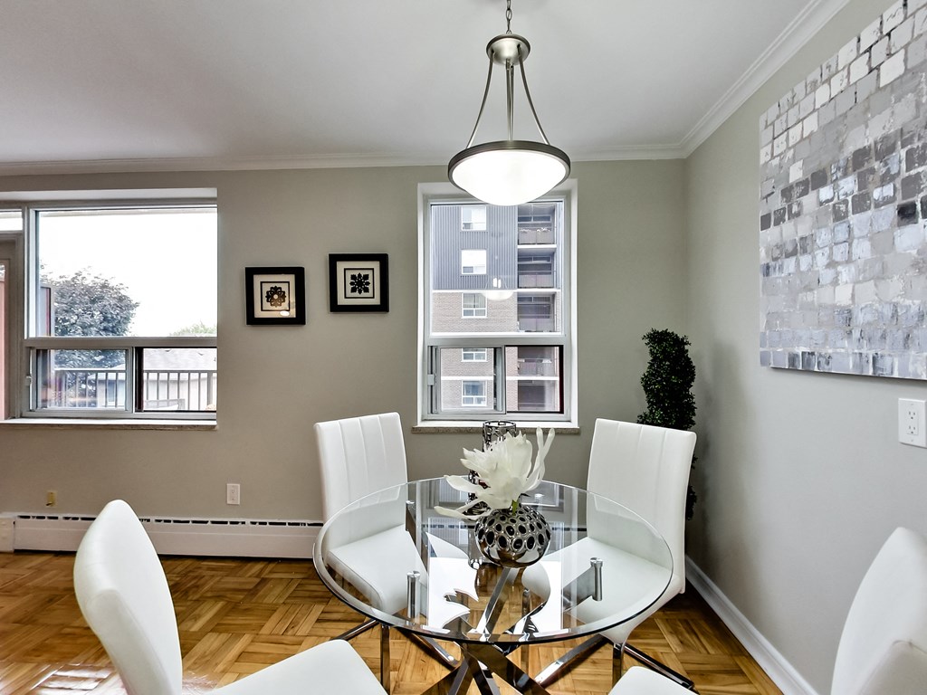 an image of a dining room with a glass table and chairs