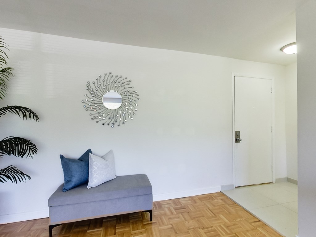 a living room with a couch and a mirror on the wall