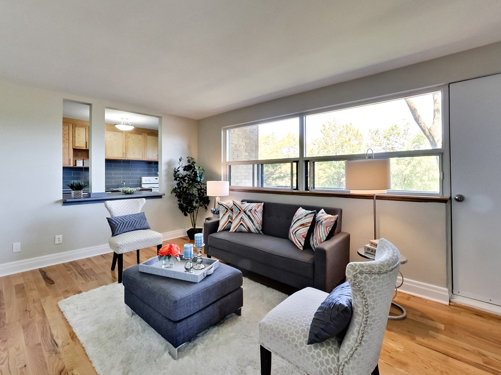 A living room with a grey couch and a grey chair.