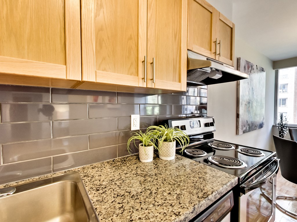 an updated kitchen with granite counter tops and stainless steel appliances
