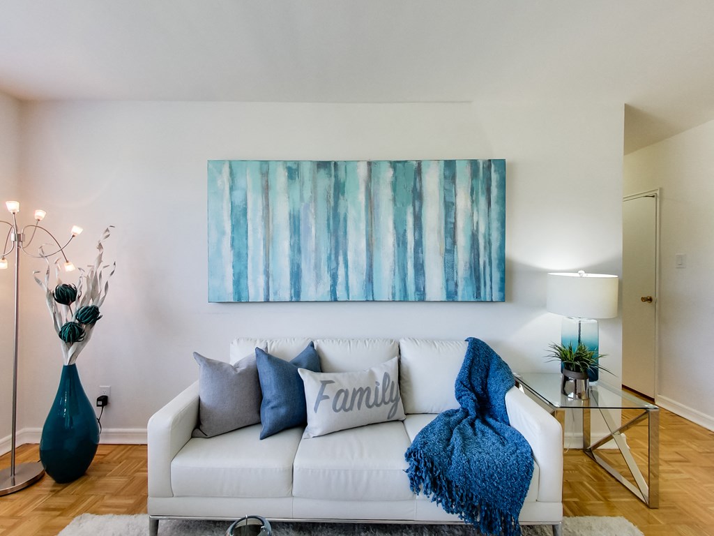 a living room with a couch and a painting on the wall