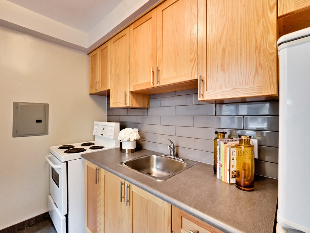 a kitchen with white appliances and wooden cabinets