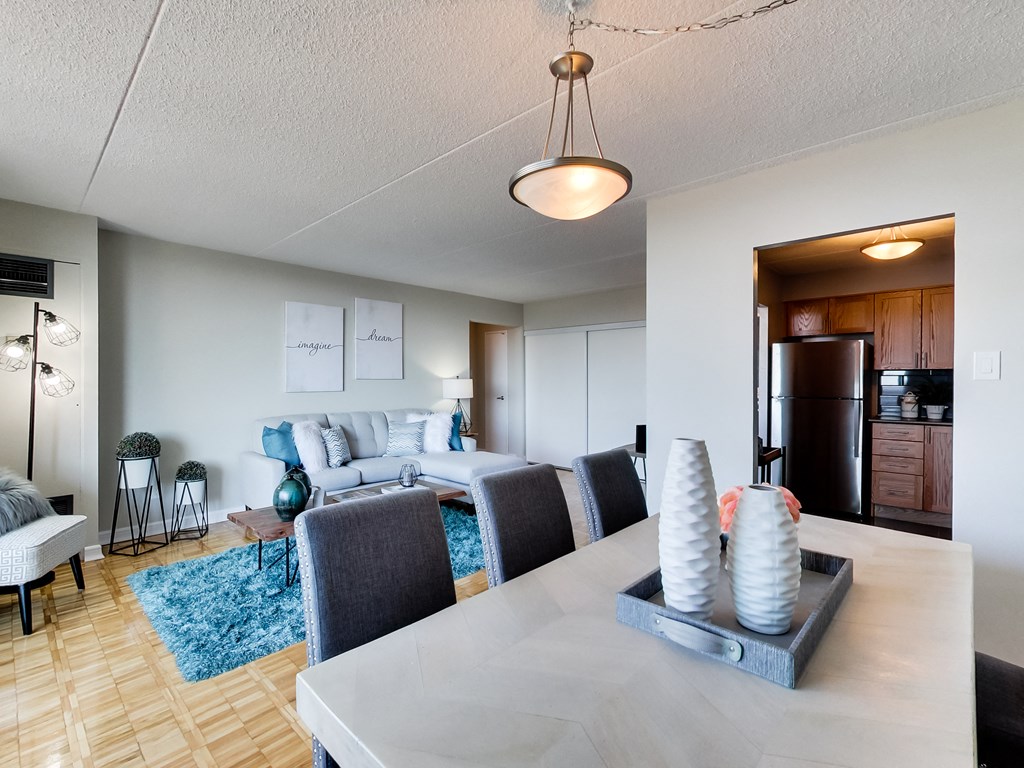 a living room and dining room with a table and chairs