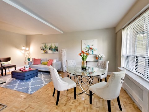 a living room with a table and chairs and a couch