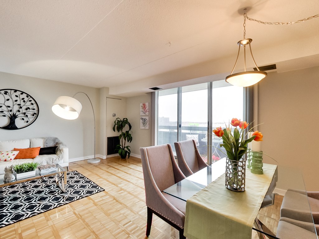 a living room and dining room with a table and chairs