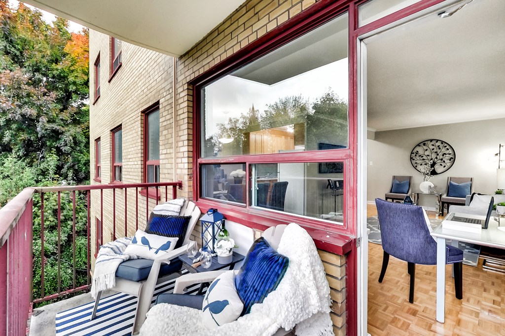 a balcony with patio furniture and a table with chairs
