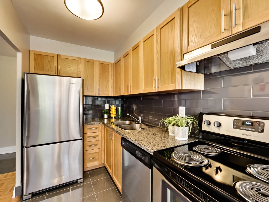 a kitchen with stainless steel appliances and wooden cabinets