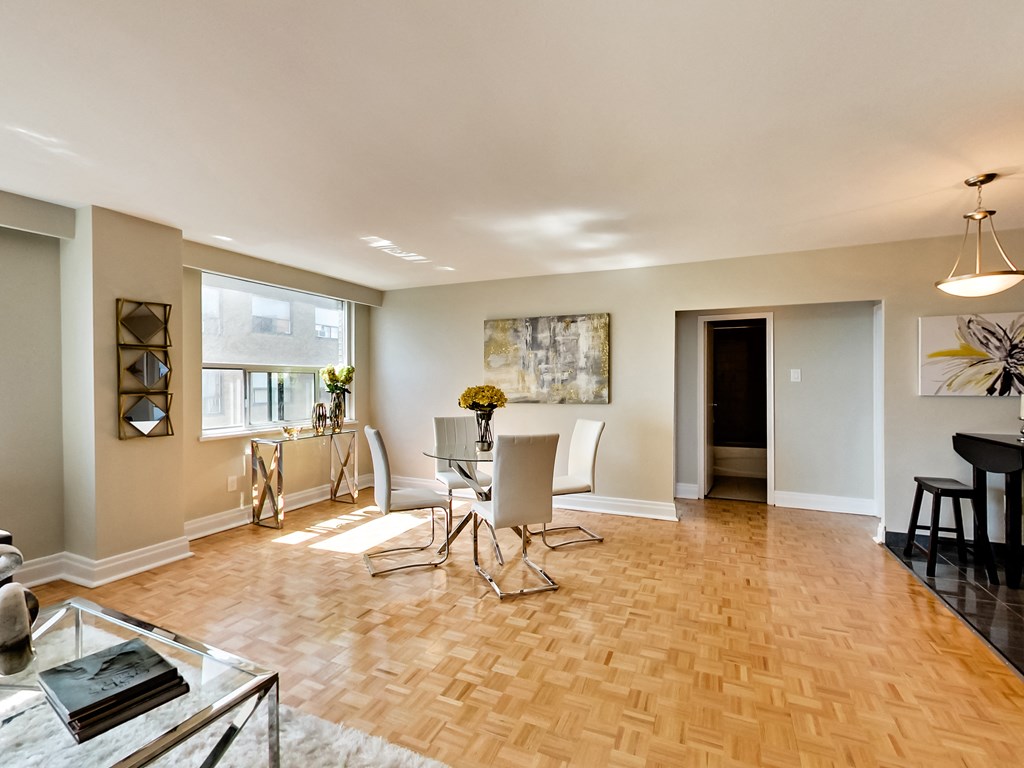 an open living room and dining room with a table and chairs