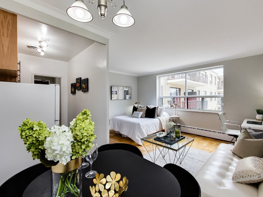 a living room with a couch and a table and a bed
