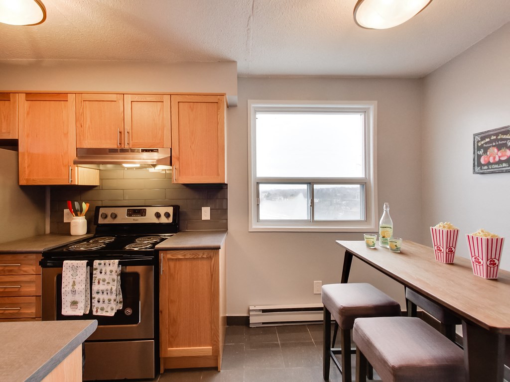 a kitchen with wooden cabinets and a table with chairs