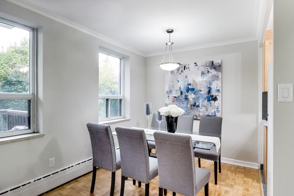 an image of a dining room with a table and chairs