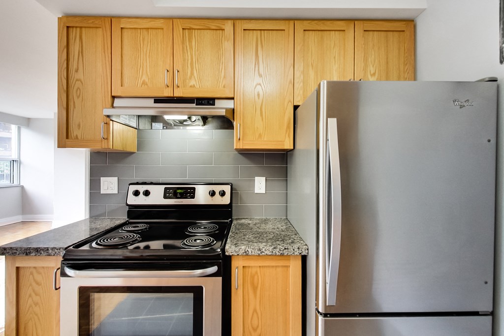 a kitchen with stainless steel appliances and wooden cabinets