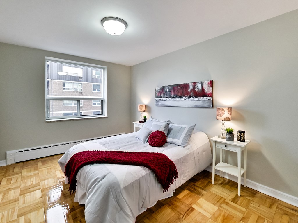 a bedroom with a white bed and a window