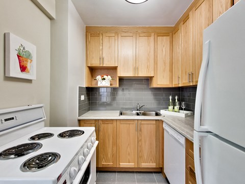 a kitchen with white appliances and wooden cabinets