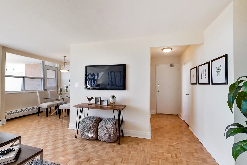 A living room with a wooden floor and a white wall.