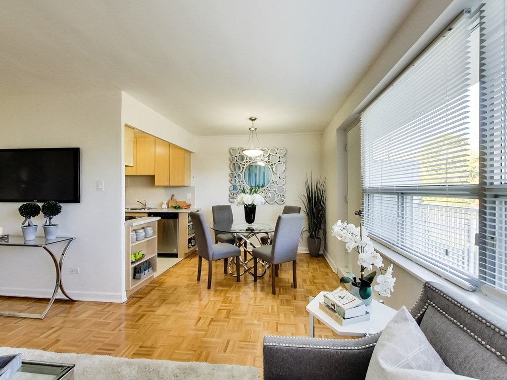 a living room and dining room with a table and chairs