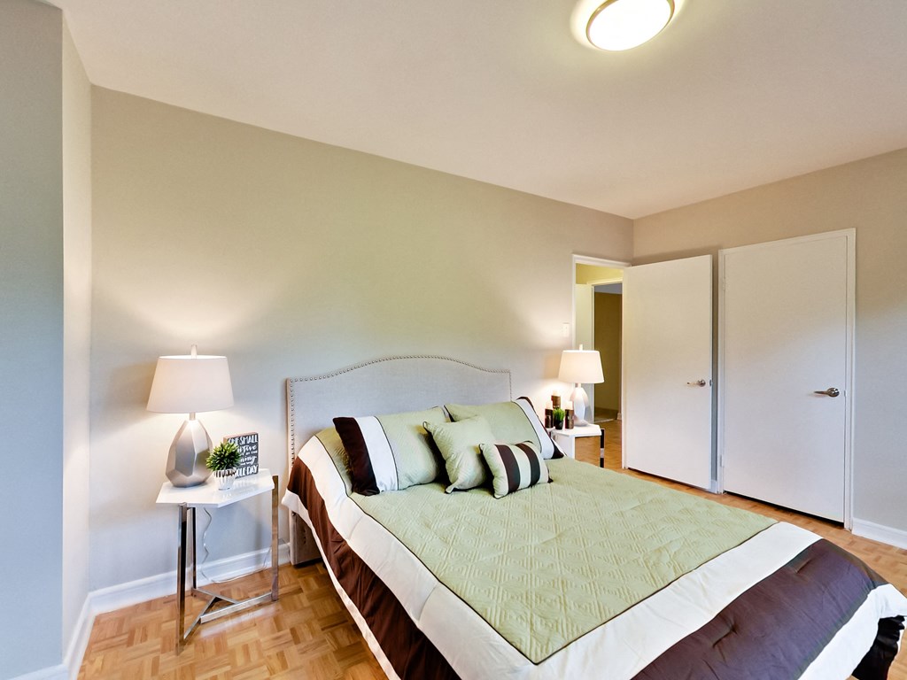 a bedroom with a large bed and a closet