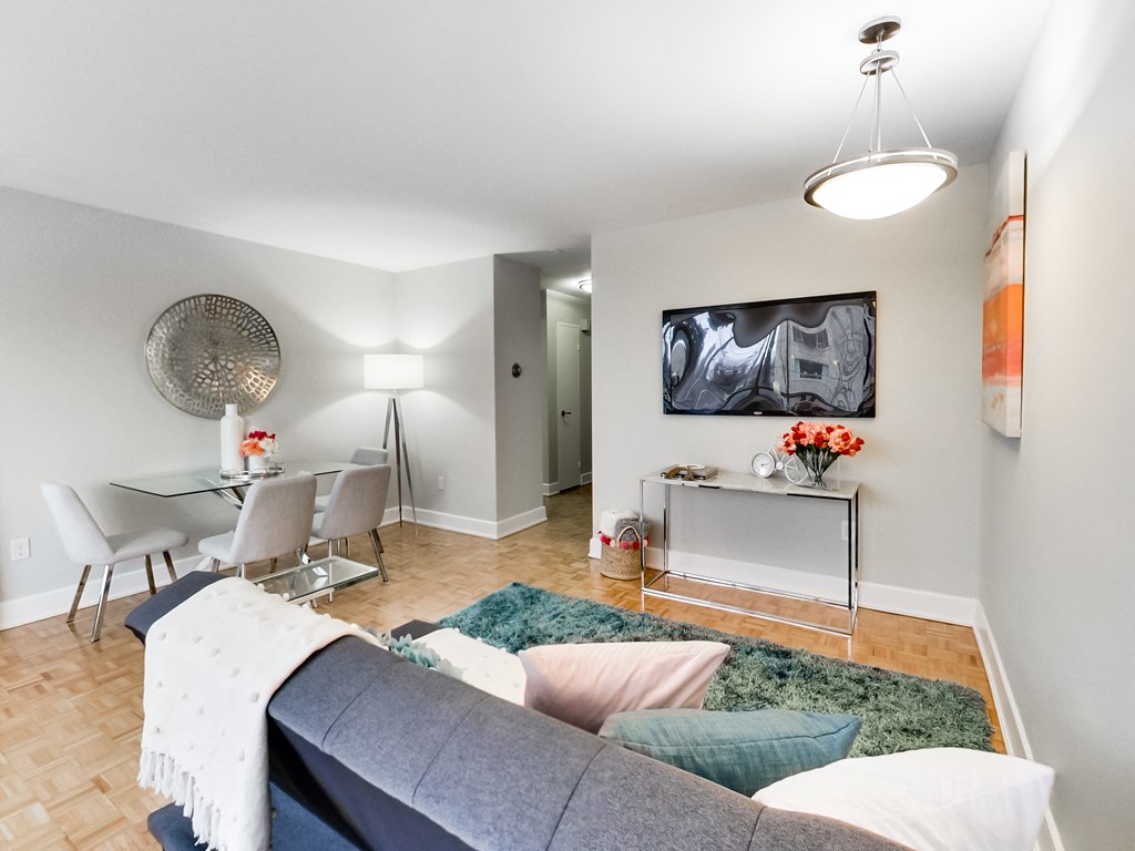A living room with a grey couch and a white coffee table.