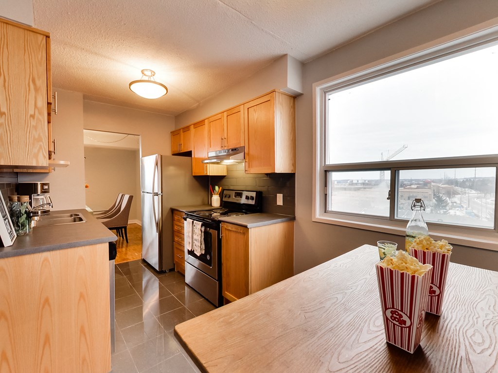 full kitchen with stainless steel appliances and a large window