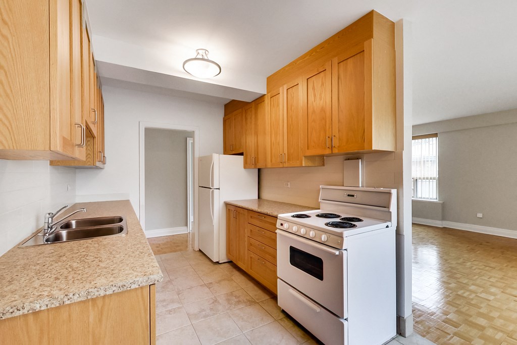 a kitchen with white appliances and wooden cabinets