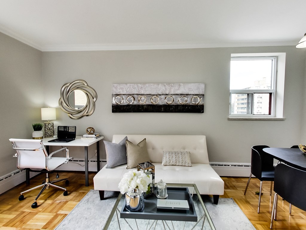 a living room with a white couch and a glass coffee table
