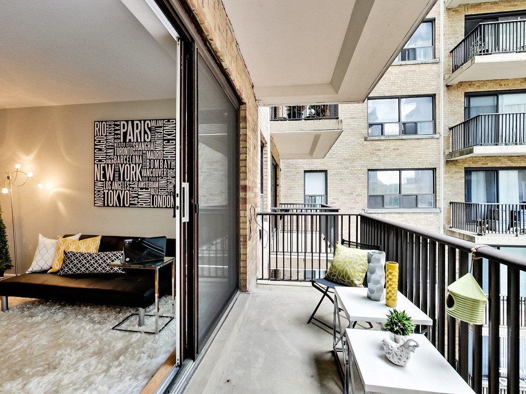 a living room with a couch and a table on a balcony