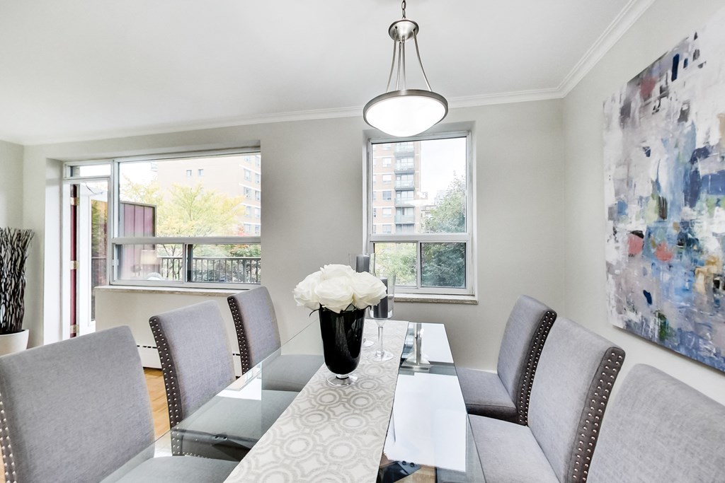 a dining room with a glass table and chairs