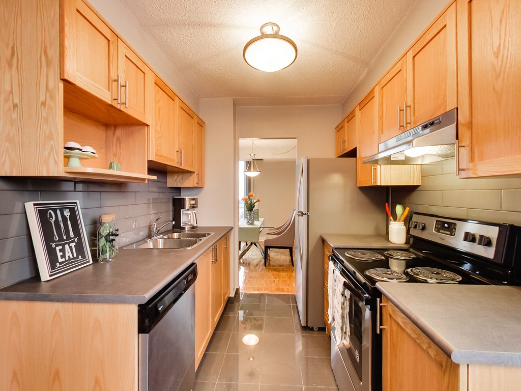 a kitchen with stainless steel appliances and wooden cabinets