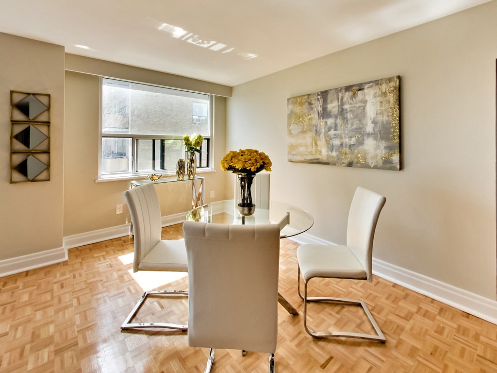 a dining room with a table and chairs and a window