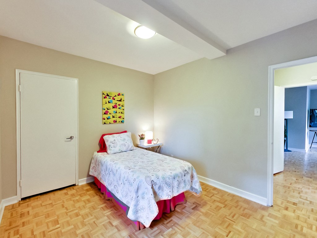 a bedroom with a bed and a door to a bathroom