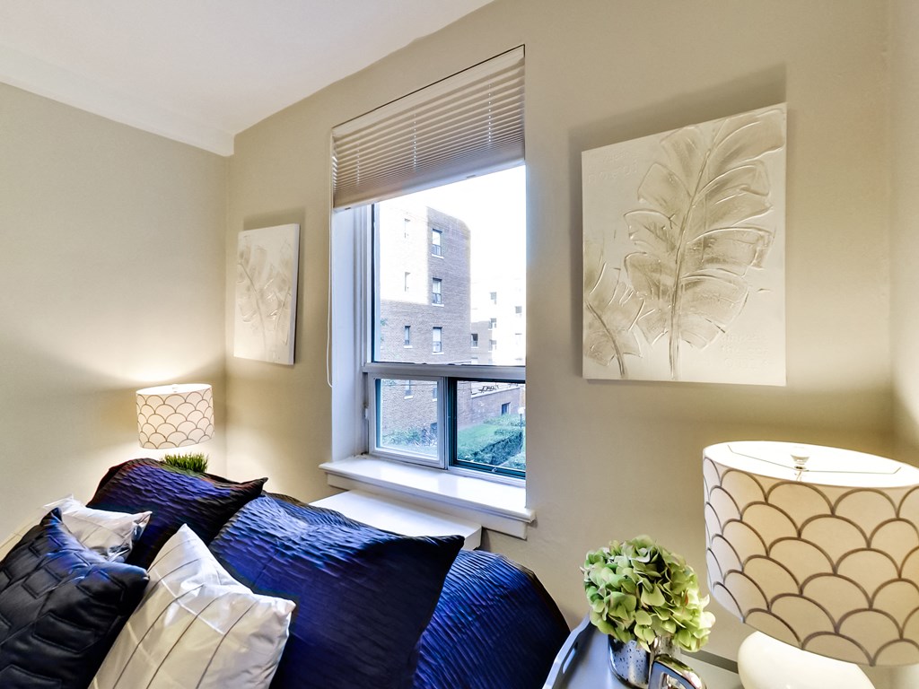 a living room with a blue couch and a window