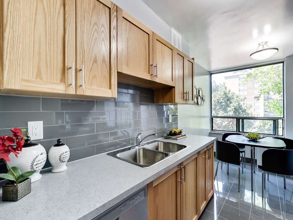 A kitchen with wooden cabinets and a grey countertop.