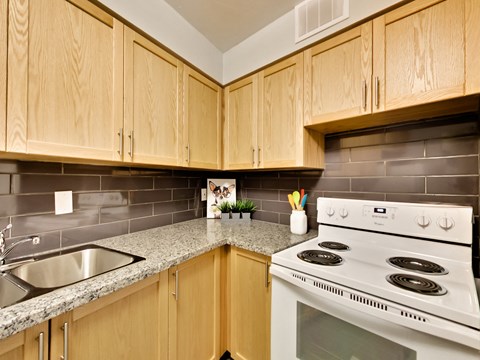 a kitchen with white appliances and granite counter tops