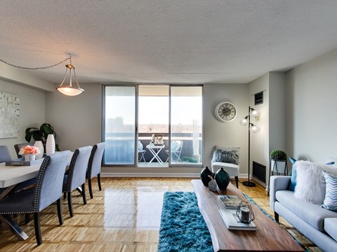 A living room with a dining table and chairs.