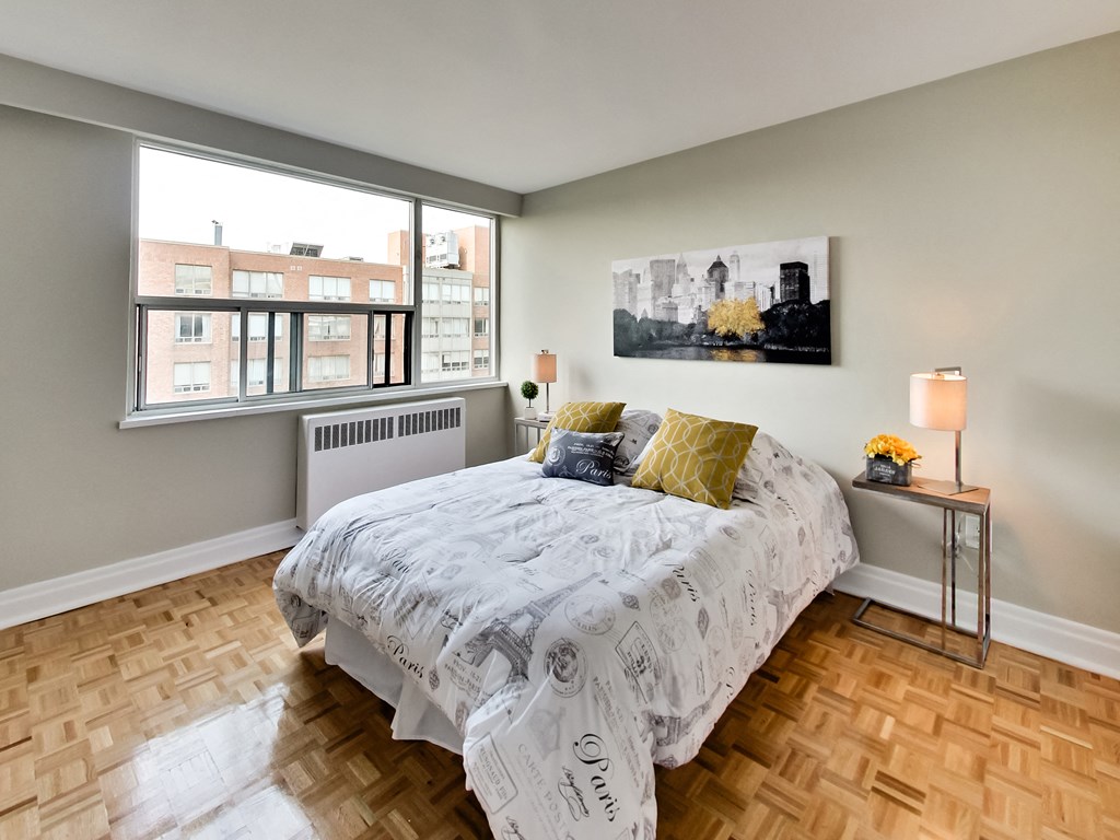 a bedroom with a bed and a large window