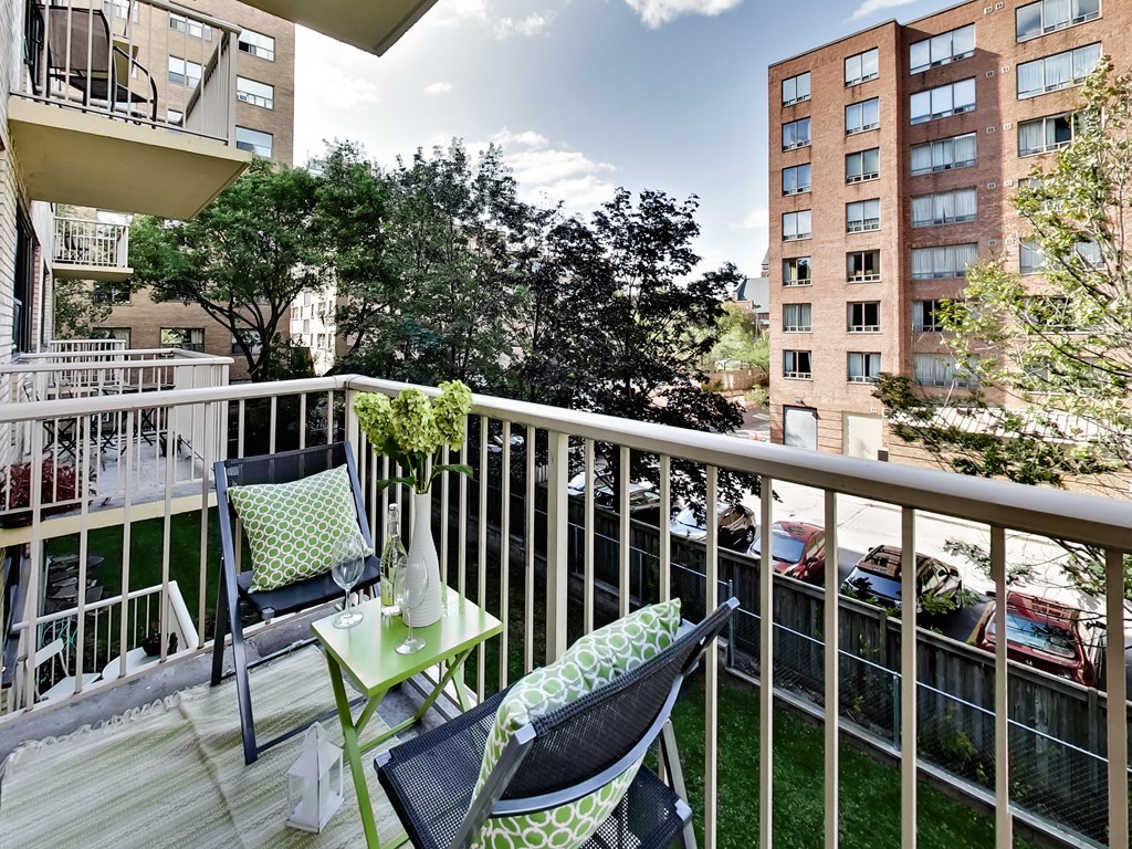 a balcony with two chairs and a table
