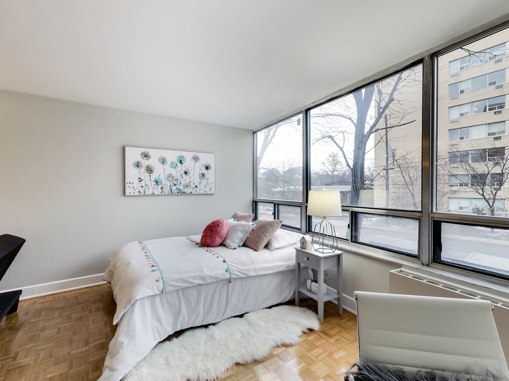 A bedroom with a large bed and a painting on the wall.