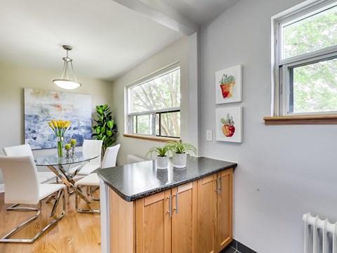 A kitchen with a table and chairs.