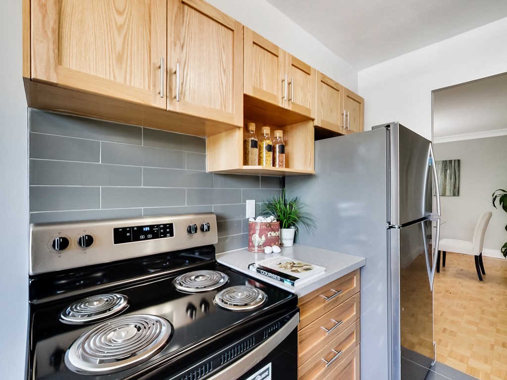 A modern kitchen with a stove top oven and a refrigerator.