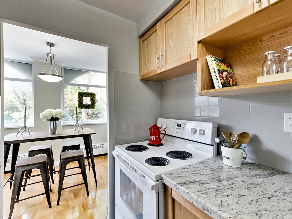A kitchen with a white stove top oven and a counter top.