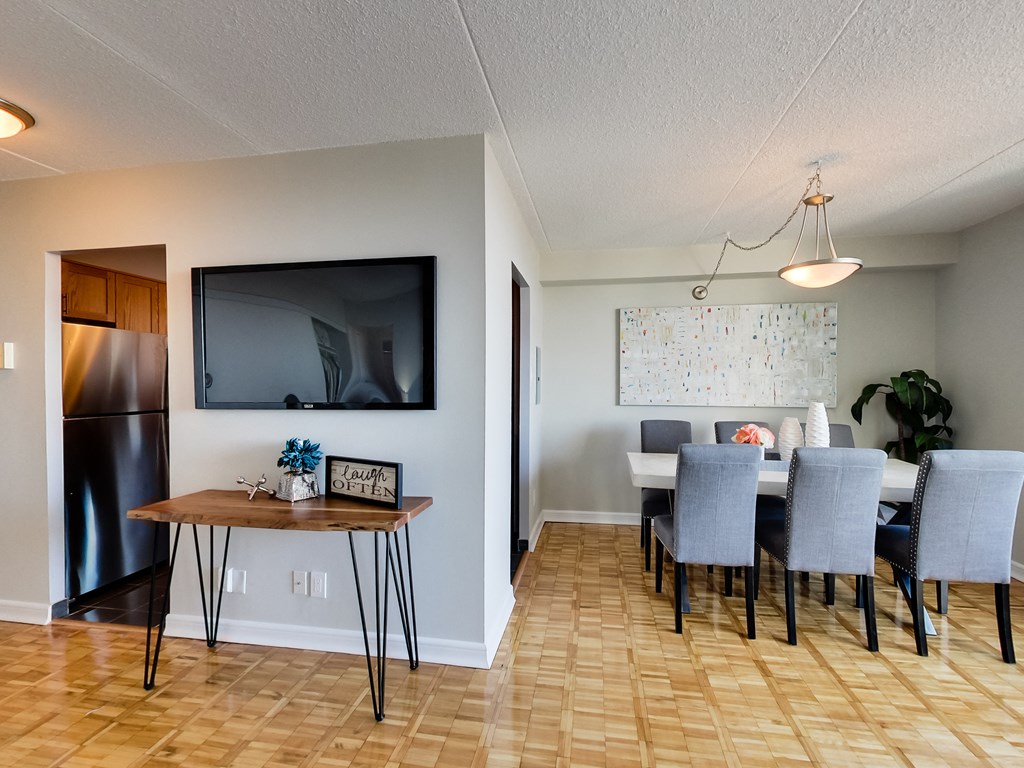 the living room and dining room with a table and chairs and a tv