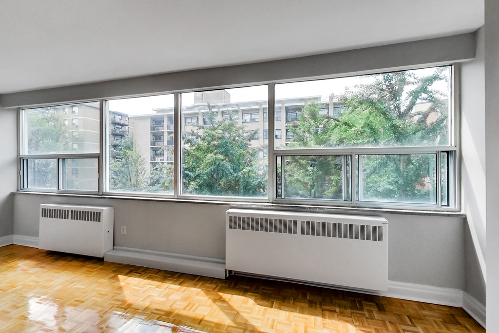 a living room with a large window and a wood floor